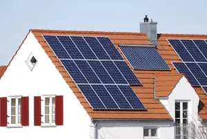 House with solar panels on red tiled roof