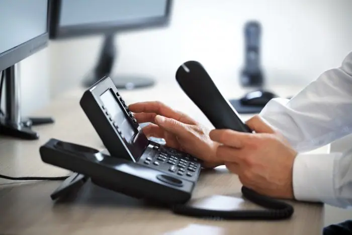 Business telephone system handset on office desk