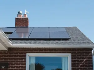 brown brick house with solar panels on roof