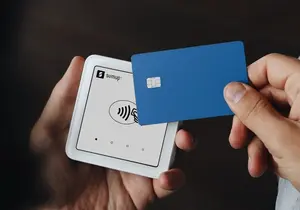A person holding a credit card in their hand
