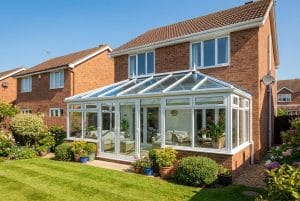 UK conservatory with a glazed glass roof at the rear of a British semi-detached home