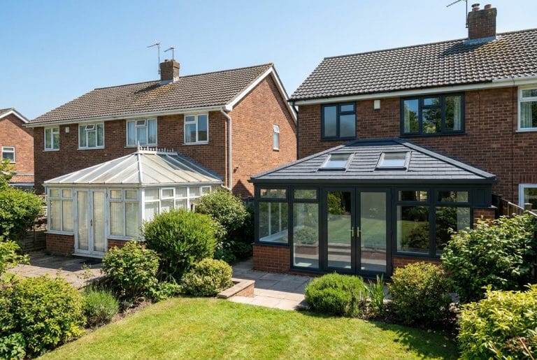 Two UK conservatories side-by-side - older glass-roof conservatory next to new tiled-roof conservatory