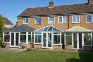 Three UK conservatories side-by-side showing tiled, glass, and polycarbonate roof types