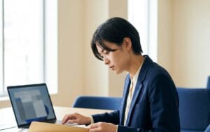 HR professional reviewing employee records folder beside laptop, UK office, illustrating GDPR Subject Access Request