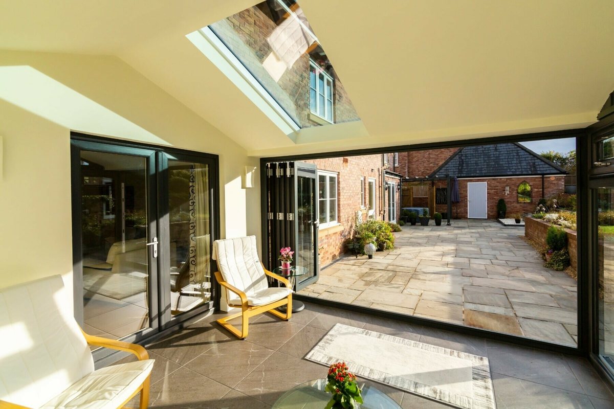 Ultraroof vaulted ceiling with a full-length glazing panel and open bi-fold doors